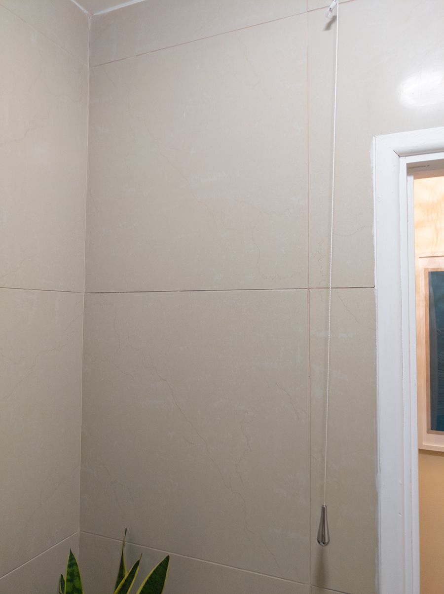 The photo shows that the shower wasn't here before, and there were just beige tiles here.