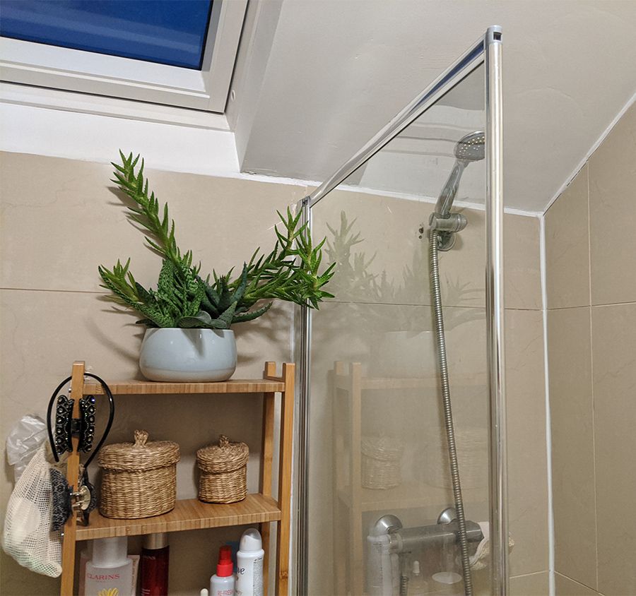 A photo showing the old open storage shelving, which was squeezed in between the bath and the loo.