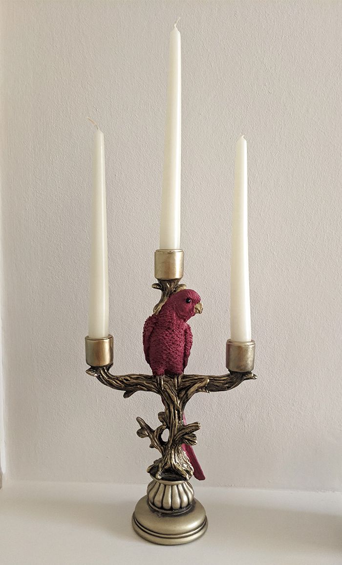 A close up of a candlestick in the middle reception room.
