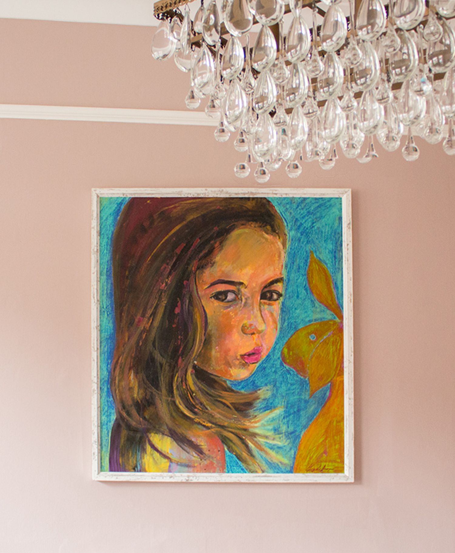 A photo of a piece of artwork of a young girl with a blue background, on pink painted walls.
