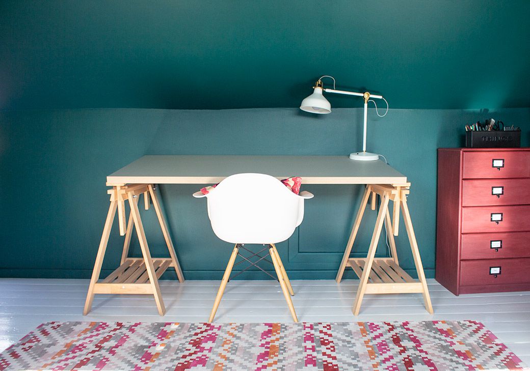 A photo of the drawing desk with the patterned rug in front.