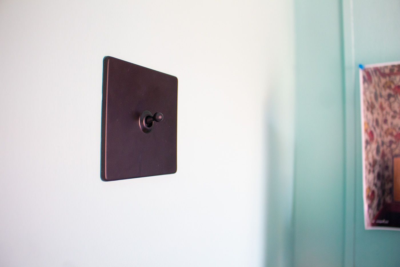 A close up shot of the new black toggle light switch.