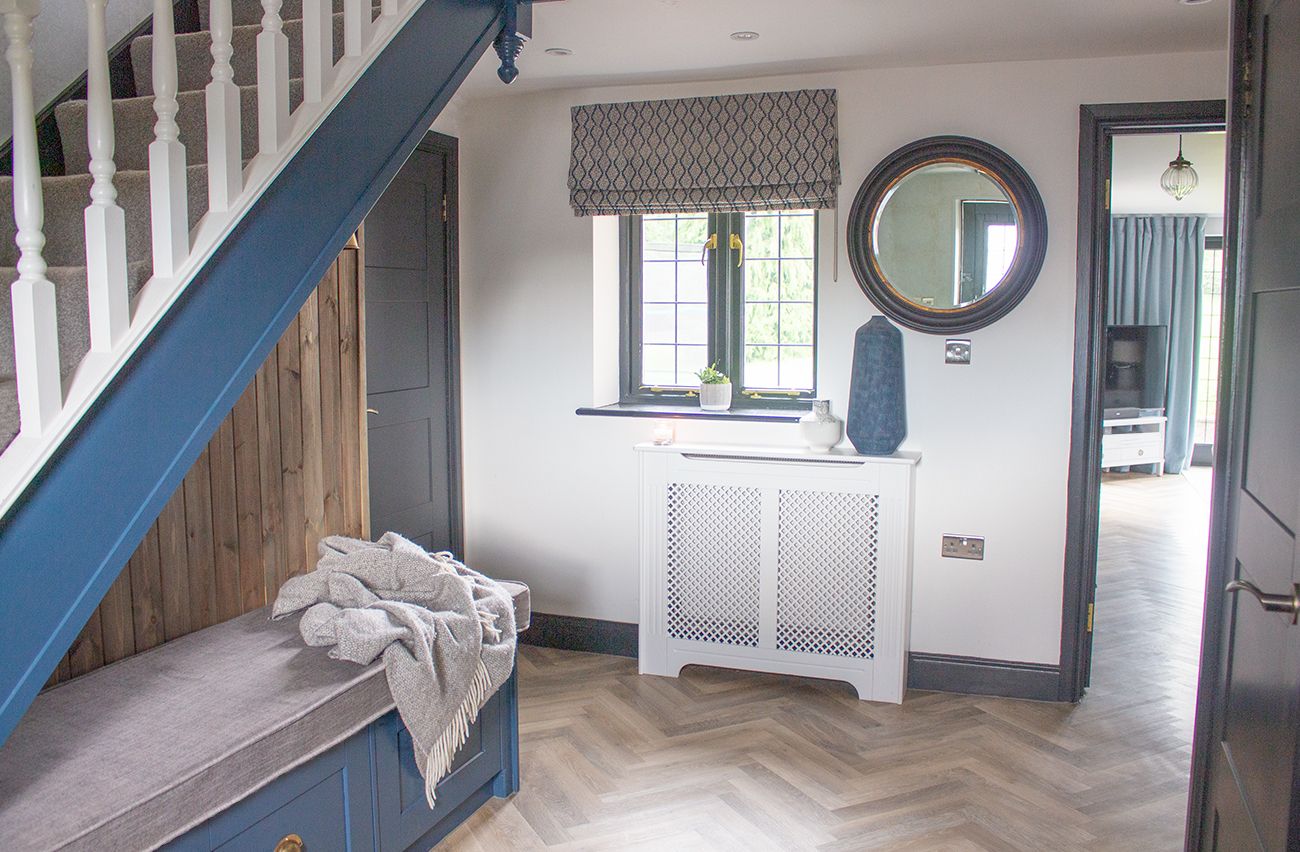 A view of the hallway showing the wooden radiator and a bespoke roman blind.