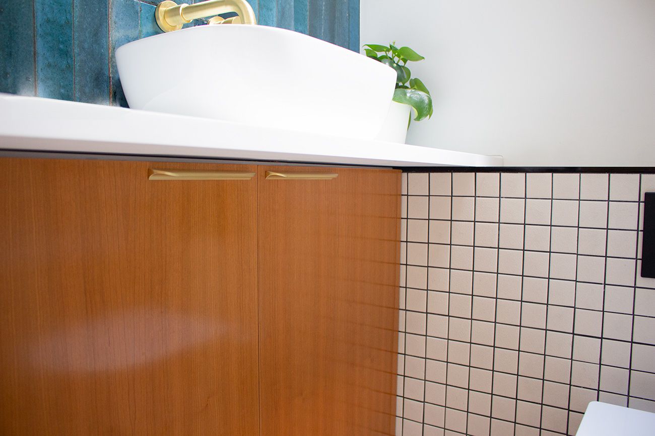 A photo of the new built in cabinets under the sink with a white worktop which the sink sits on.