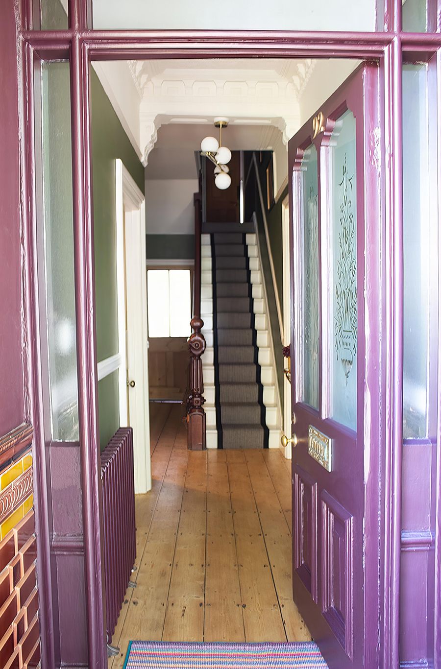A photo showing the front door open, through to the hallway.