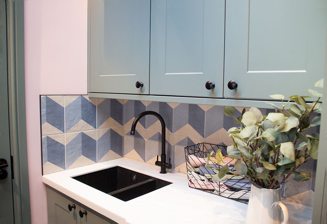 The new utility room with green cabinets and a white Corian worktop.