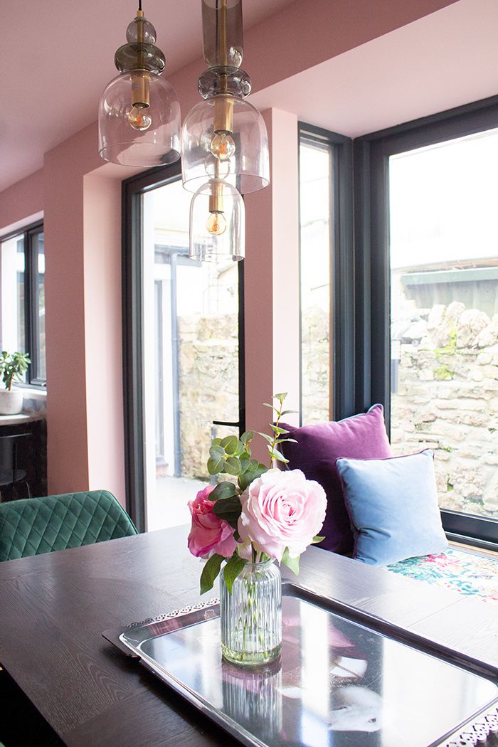 A close up of the green glass kitchen light over the dining table.