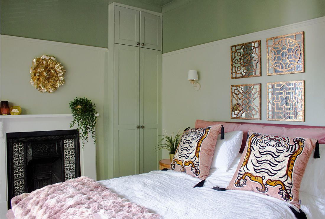 A photo of the main bedroom with built in wardrobes and a luxurious pink velvet bed.