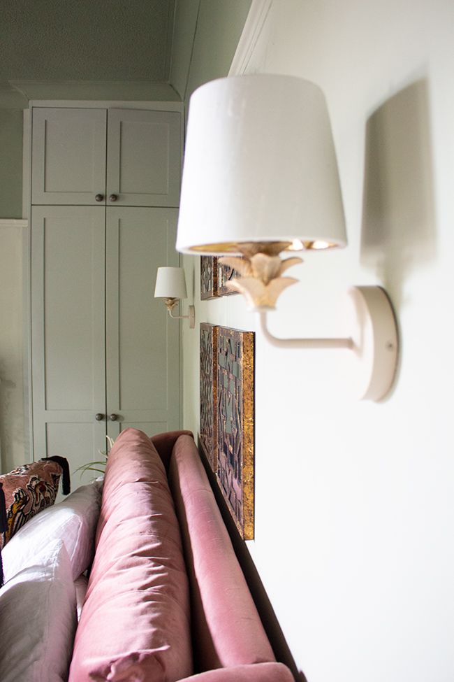 A view looking along the top of the velvet bed to the new wall lights in the main bedroom.