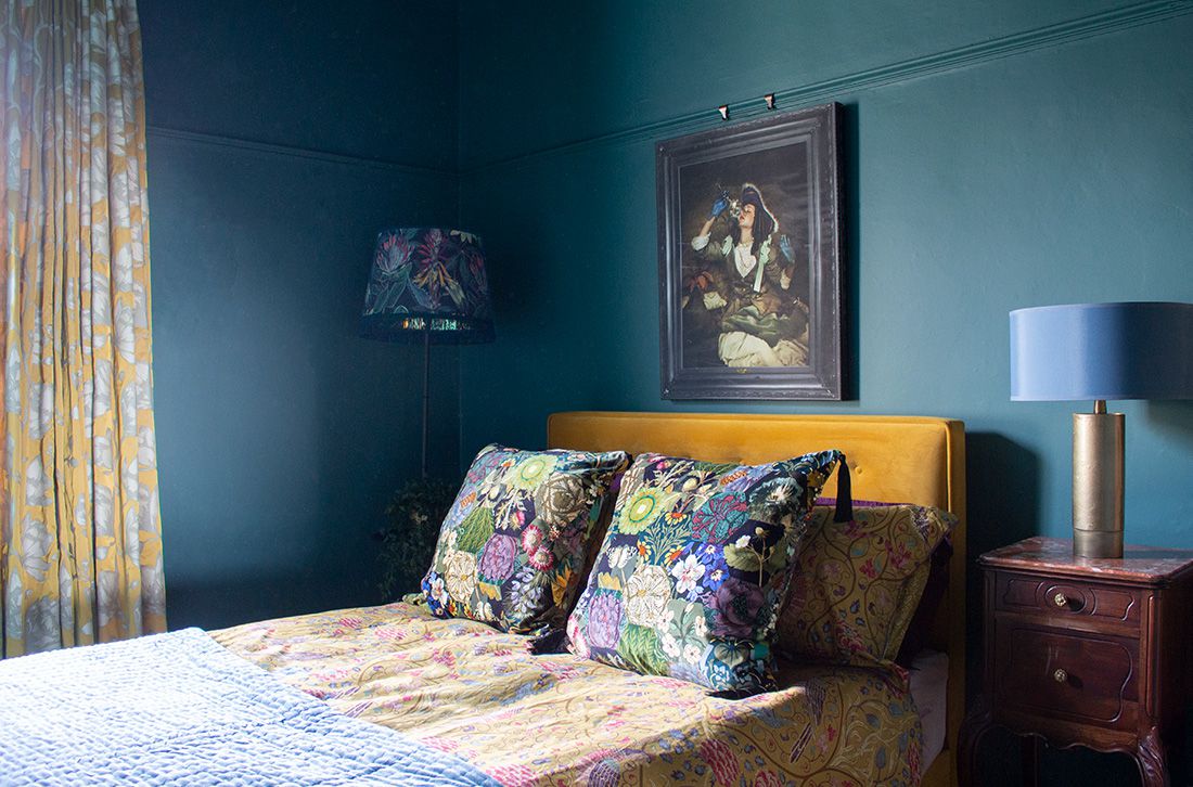 A photo of the new ochre velvet bed and the new muted yellow curtains in the middle bedroom.