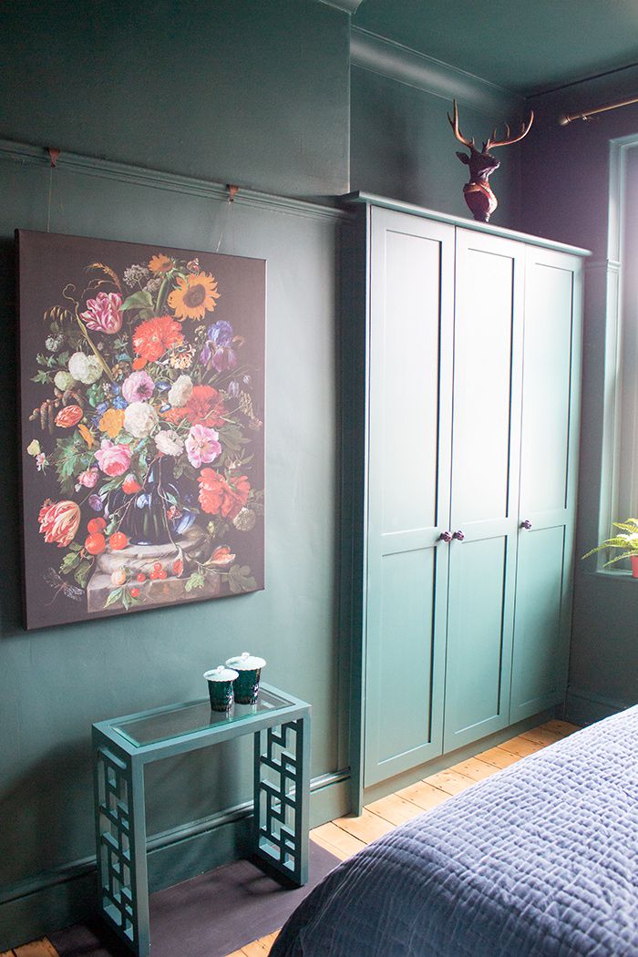 A photo of the built in wardrobes in the middle bedroom, which have been painted teal.