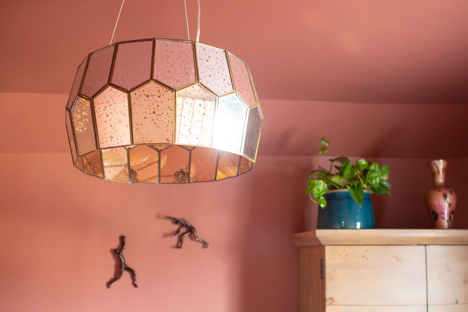 A close up of the new foxed mirror and brass ceiling light in the back guest bedroom.