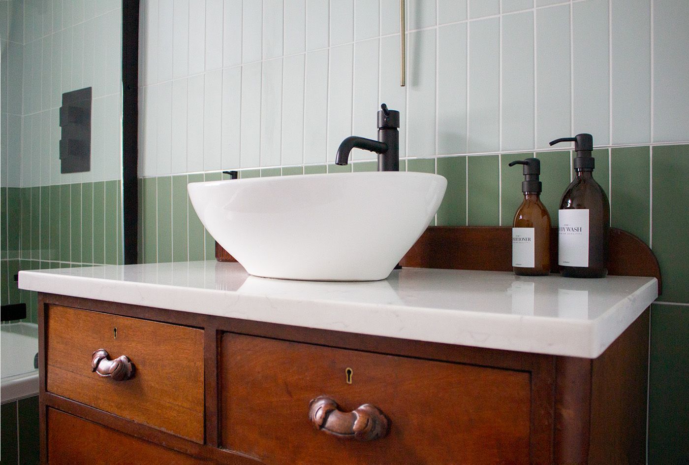 A photo of the new vanity unit in the main bathroom which has been made from a vintage dresser.