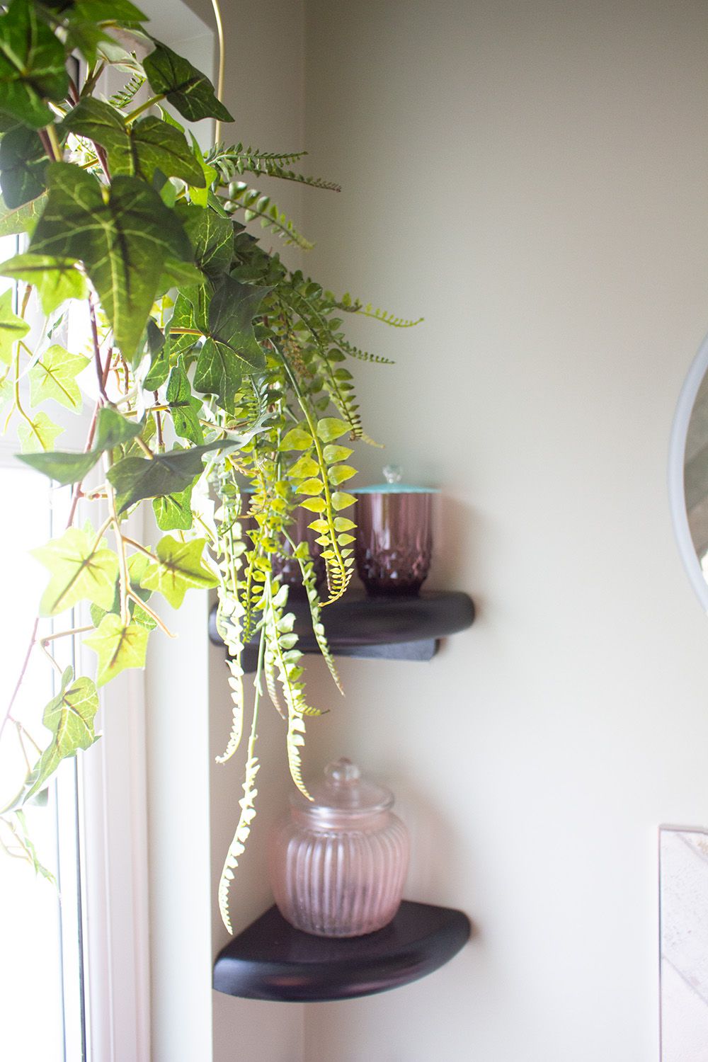 A photo of the en suite window with hanging plants as a window dressing.