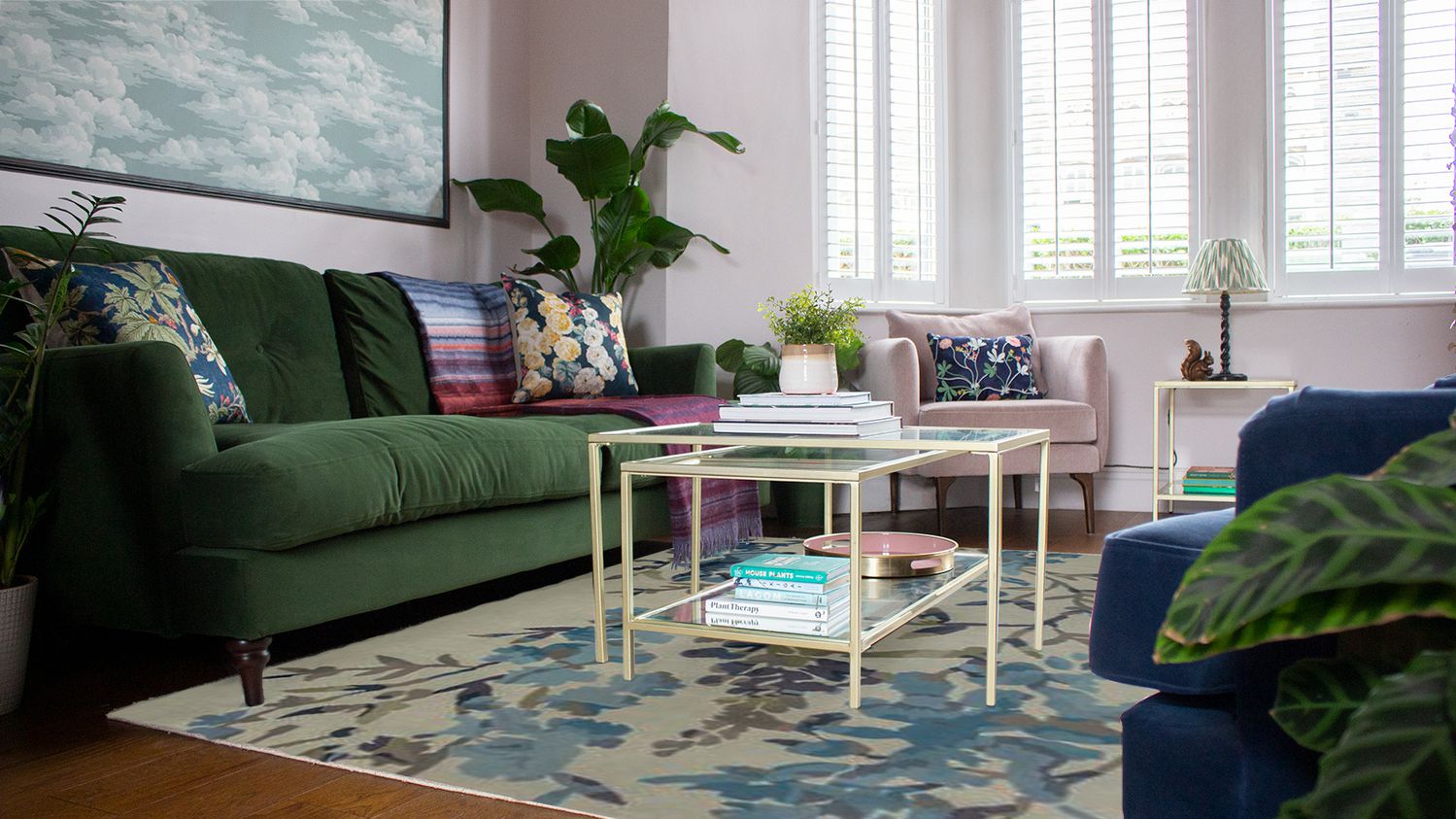 A photo taken from lower down looking past the potted plants towards the new rug and coffee tables.