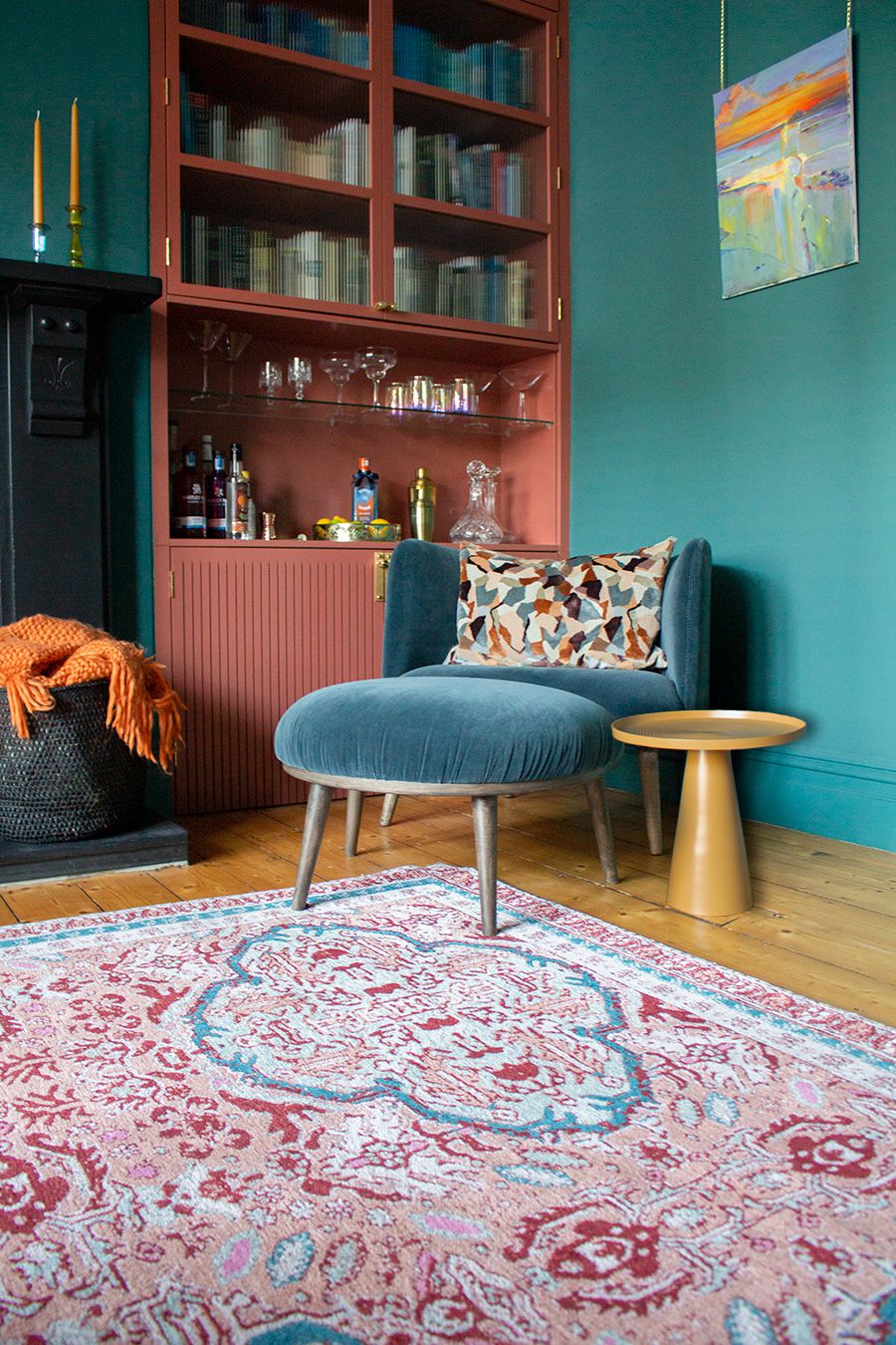 A photo showing the blue velvet chair and footstool with a mustard side table.