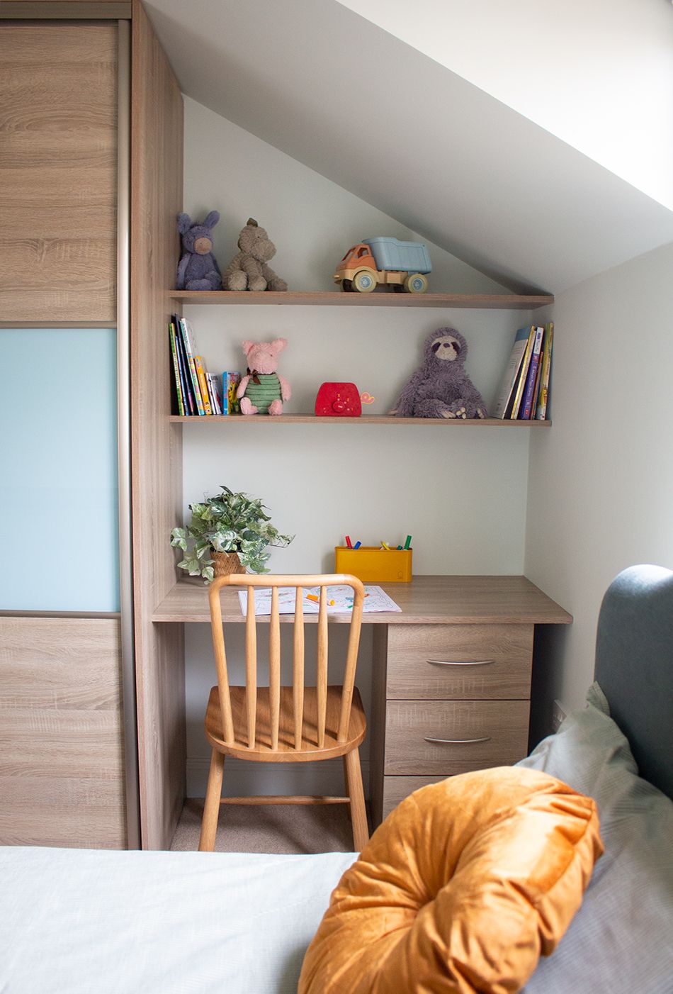 A close up photo of a child's bedroom desk and shelving.