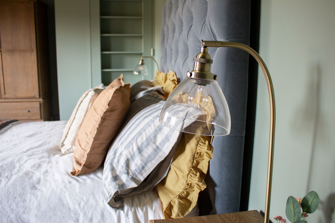 A close up photo of the glass bedside lamps in the upstairs guest bedroom.