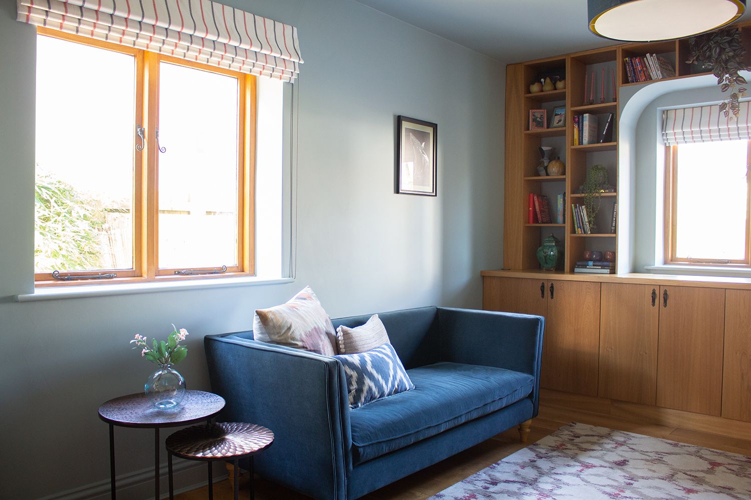 A photo of the study, with warm aqua walls and a blue velvet sofa.