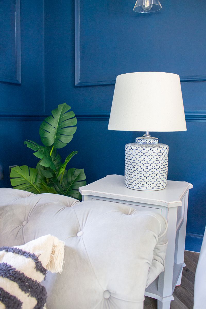 A close up of the table lamp in the living room, which has a delicate blue pattern on it.