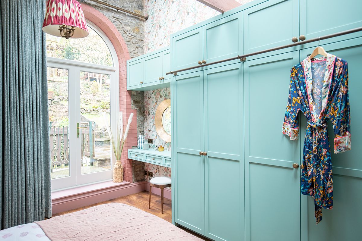 A photo showing the bespoke green wardrobes.