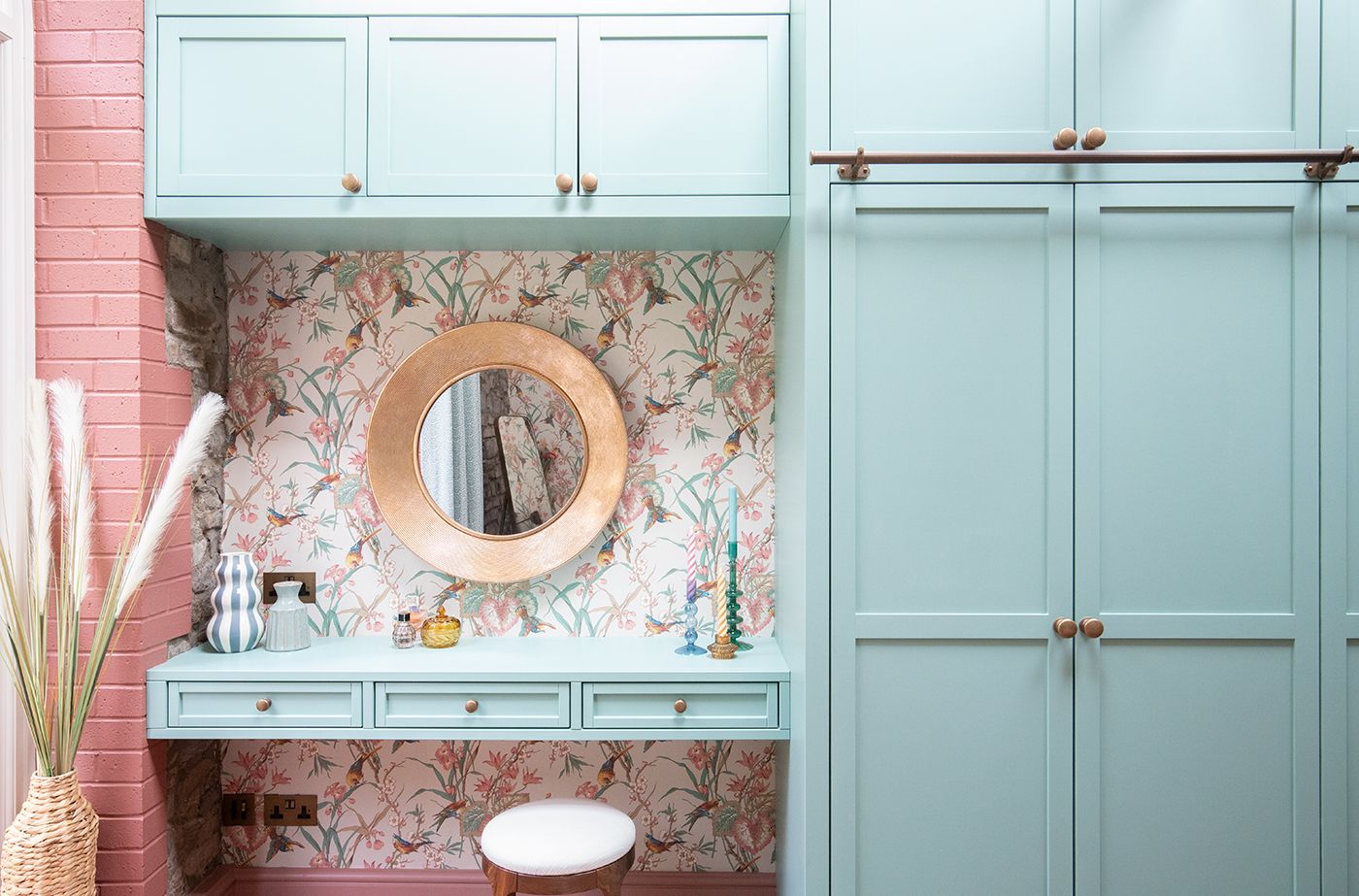 A photo looking straight at the dressing table with large brass mirror above.