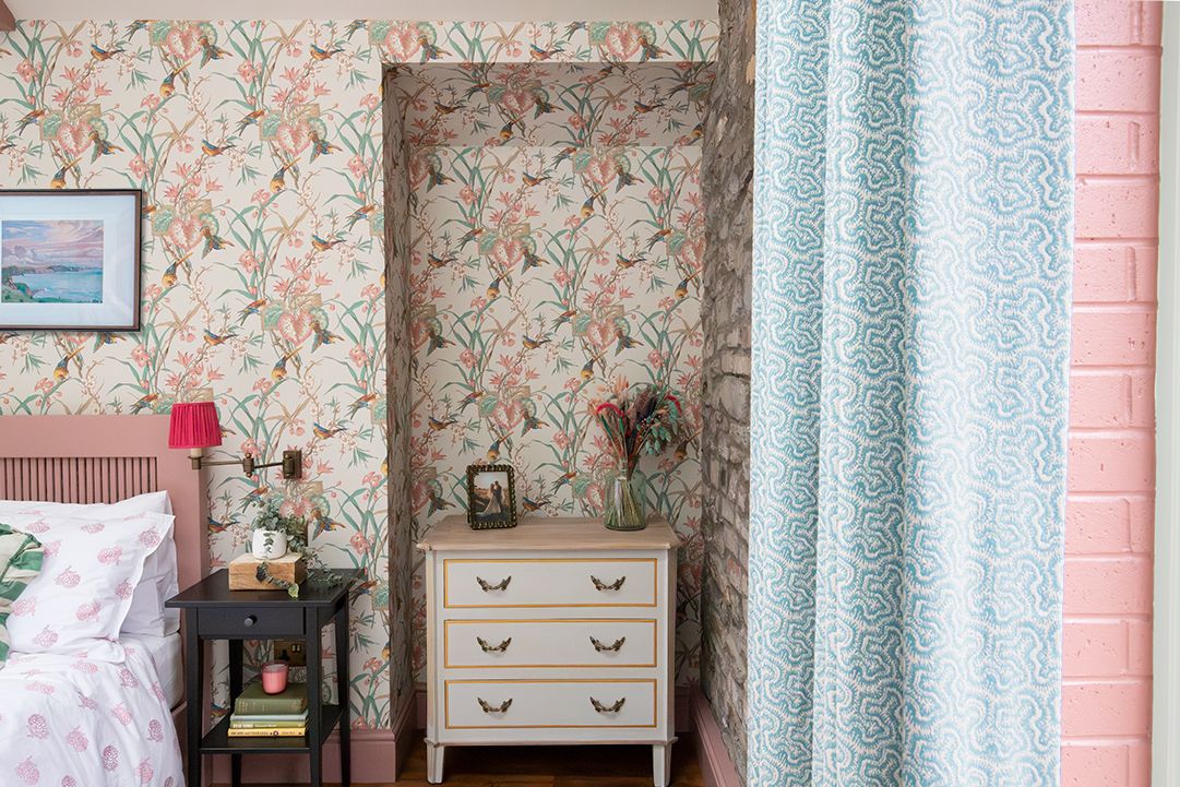 A photo looking at the white and gold chest of drawers nestled in an alcove.