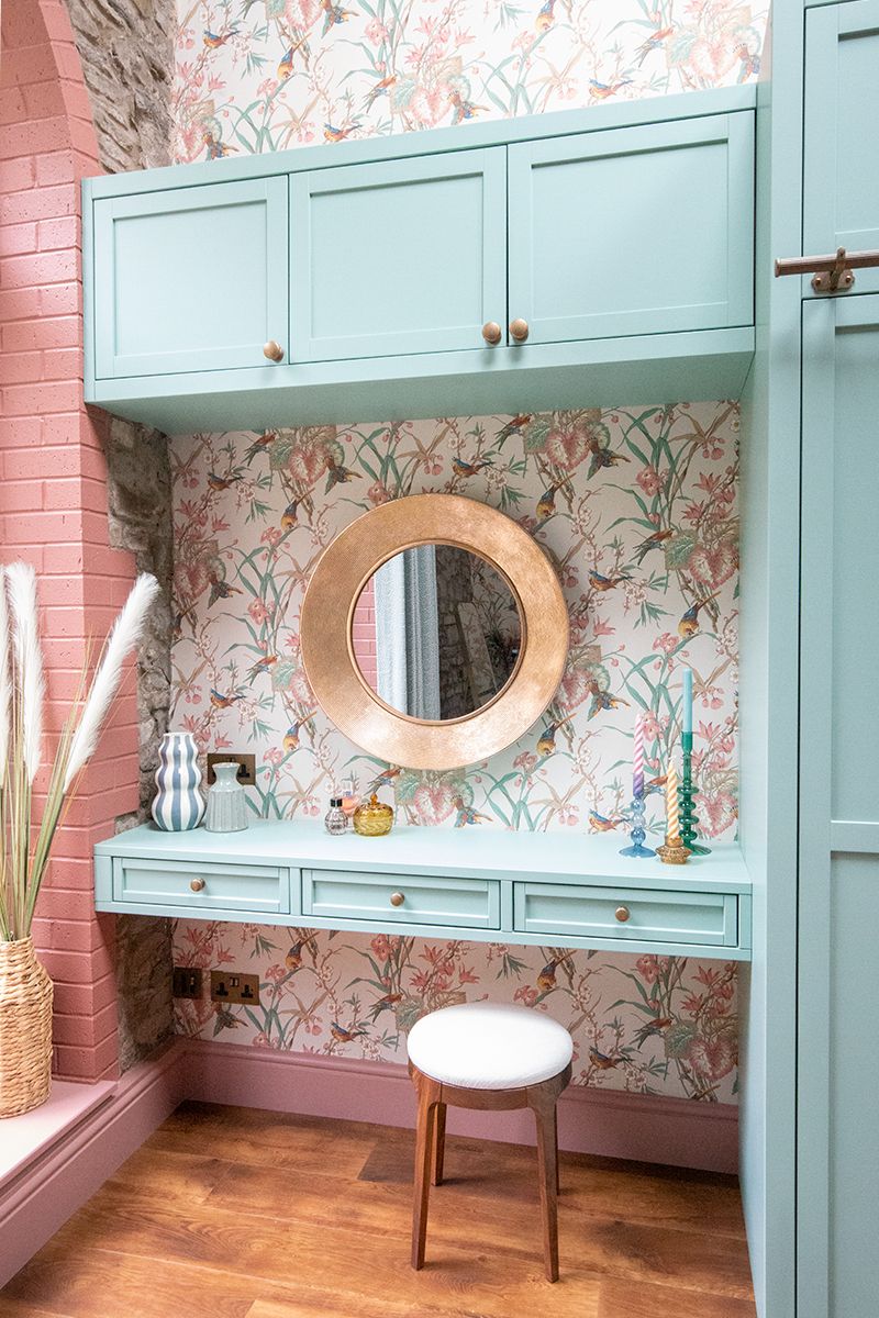 A photo showing the bespoke built in dressing table, which is painted green.