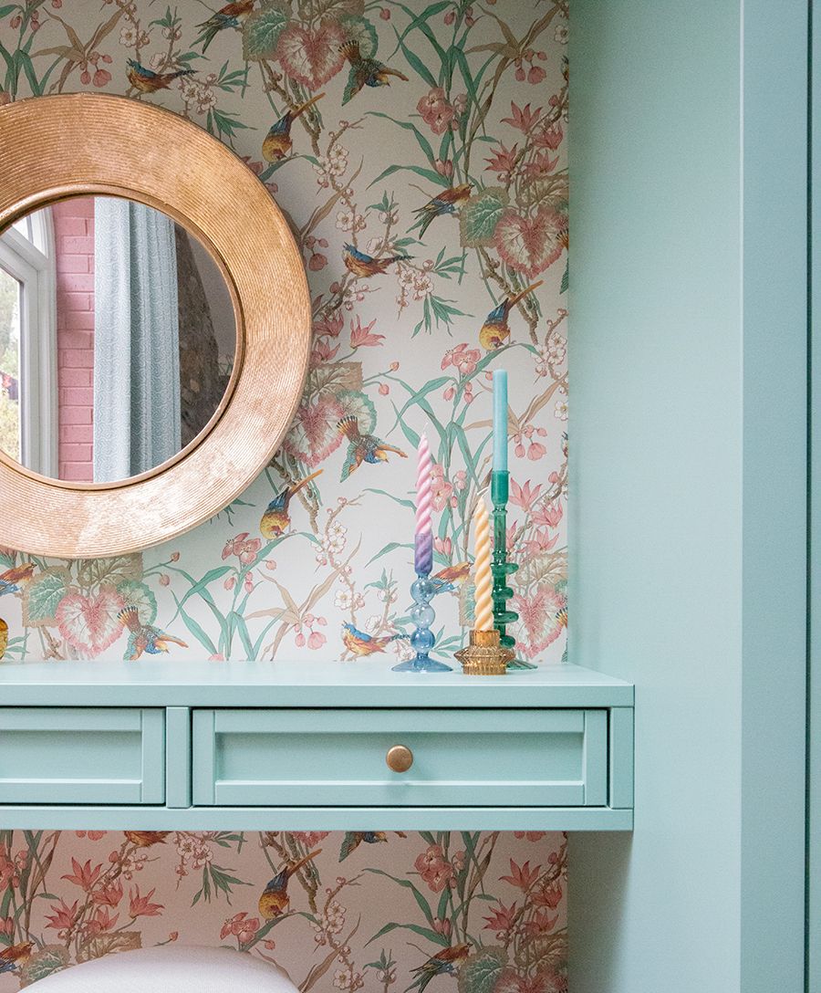 A close up photo of the dressing table with colourful glass candlesticks on it.