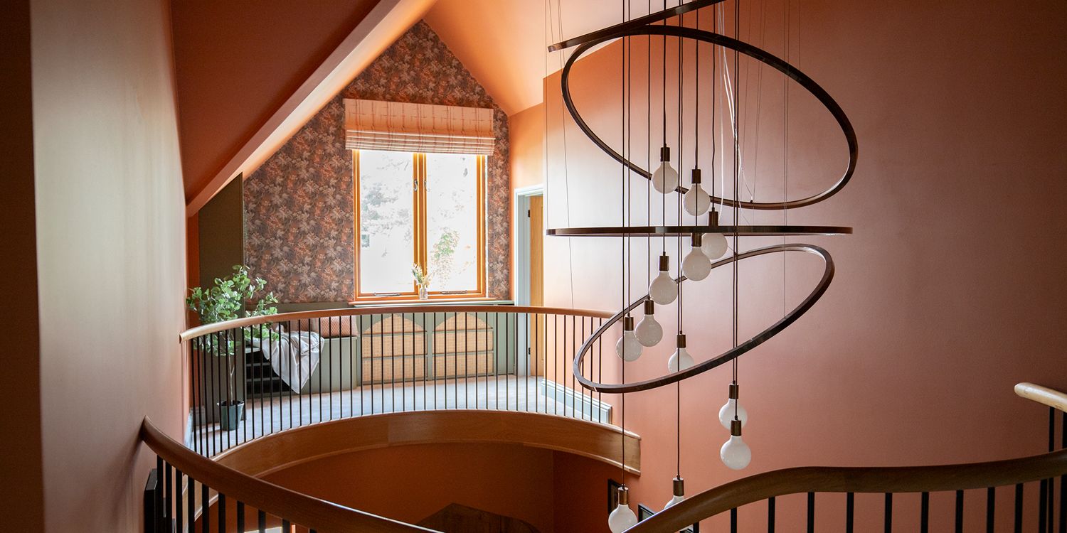 A photo of a large chandelier made of metal rings with bulbs hanging down the middle.