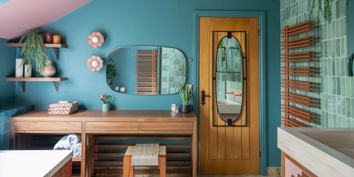 A photo of a large bathroom with green rectangular tiles and a walnut bespoke dressing table.