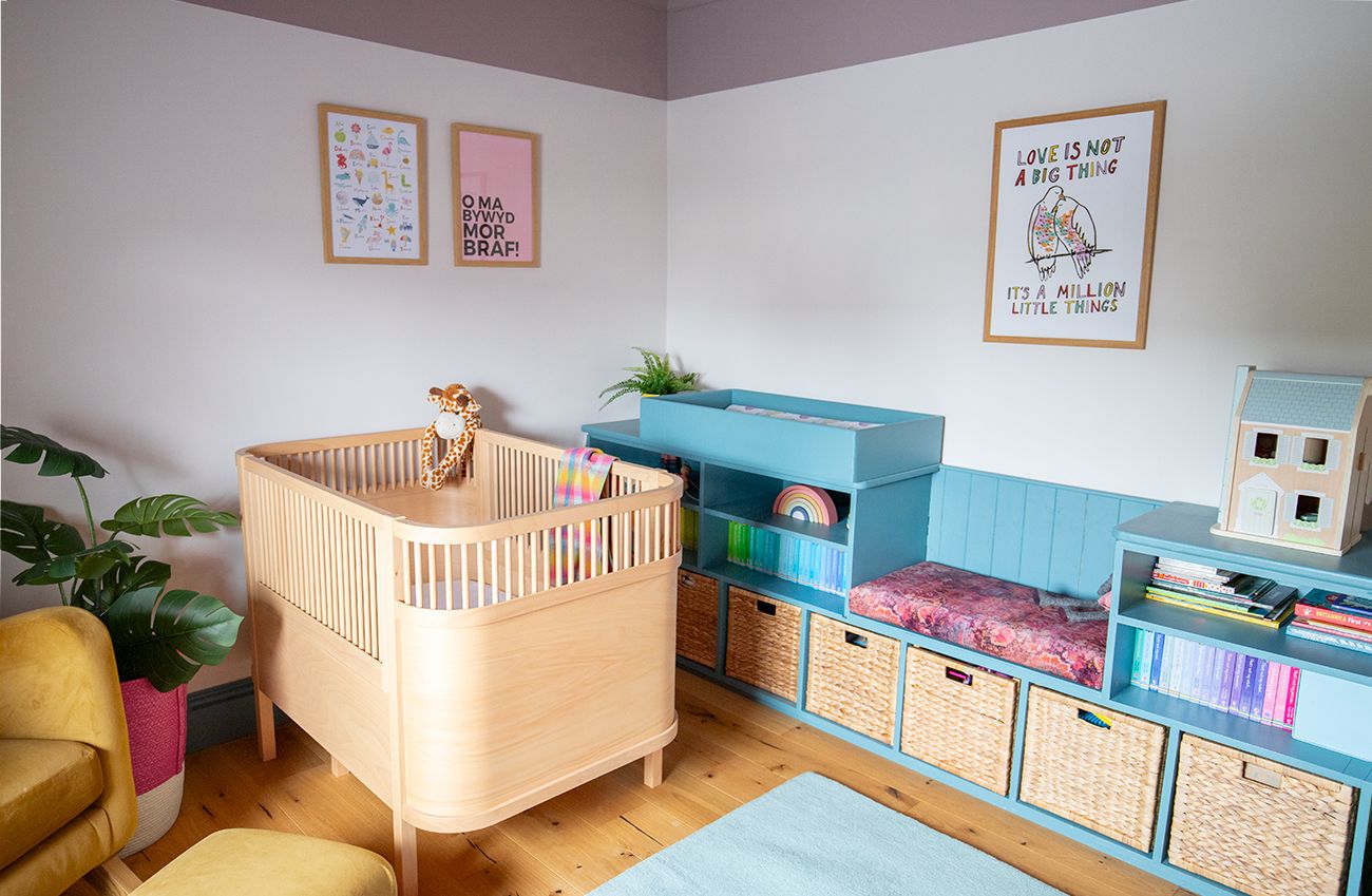 A photo showing a nursery bedroom with wooden cot