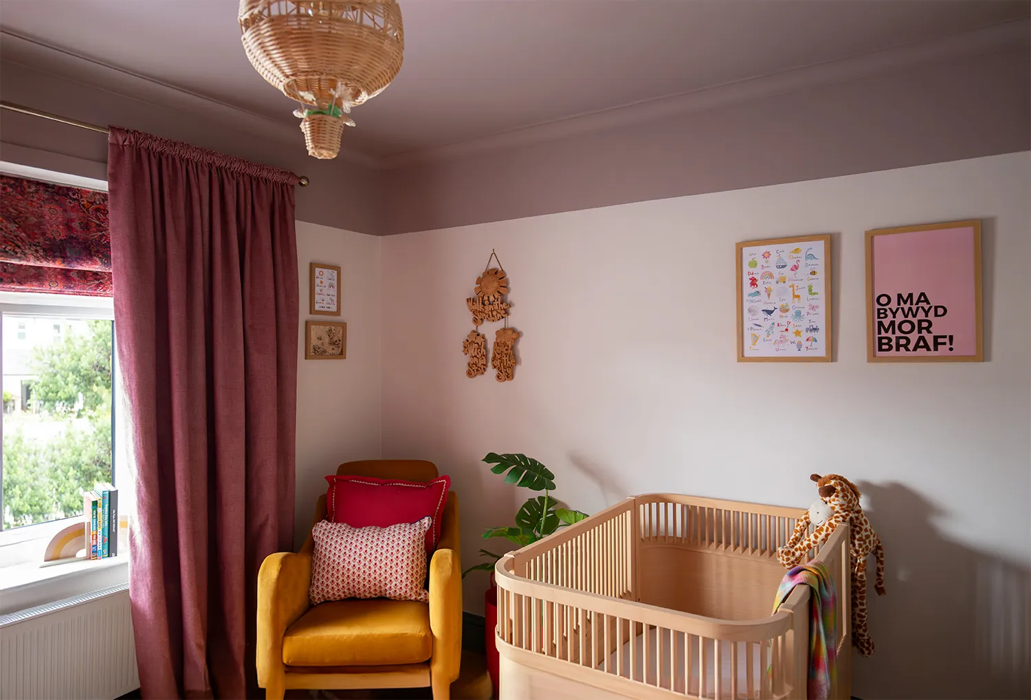 A photo of a nursery bedroom with yellow armchair