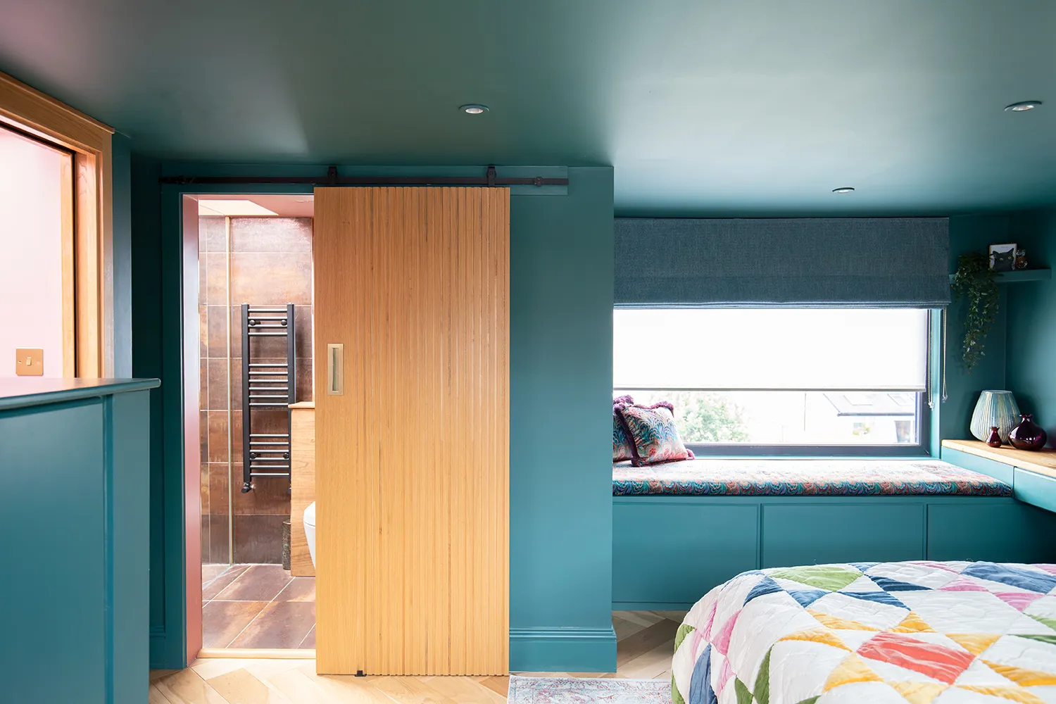 A photo showing a wooden sliding door to a en suite