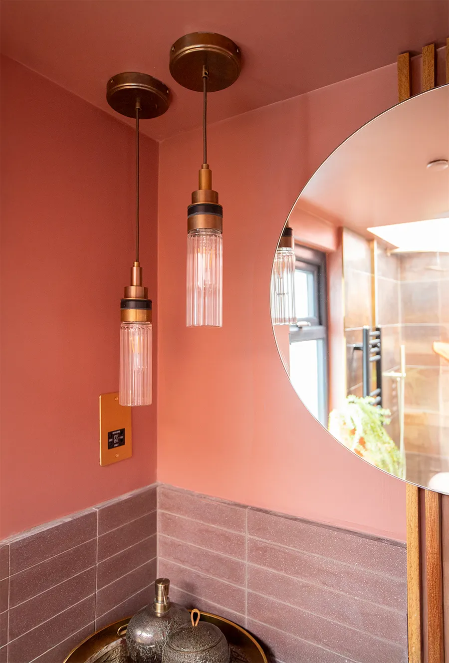 A photo of 2 pendant lights in a pink en suite