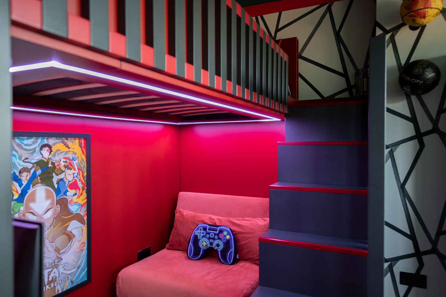 A red and dark grey slatted cabin bed with LEDs under the mattress area, lighting the gaming area below.