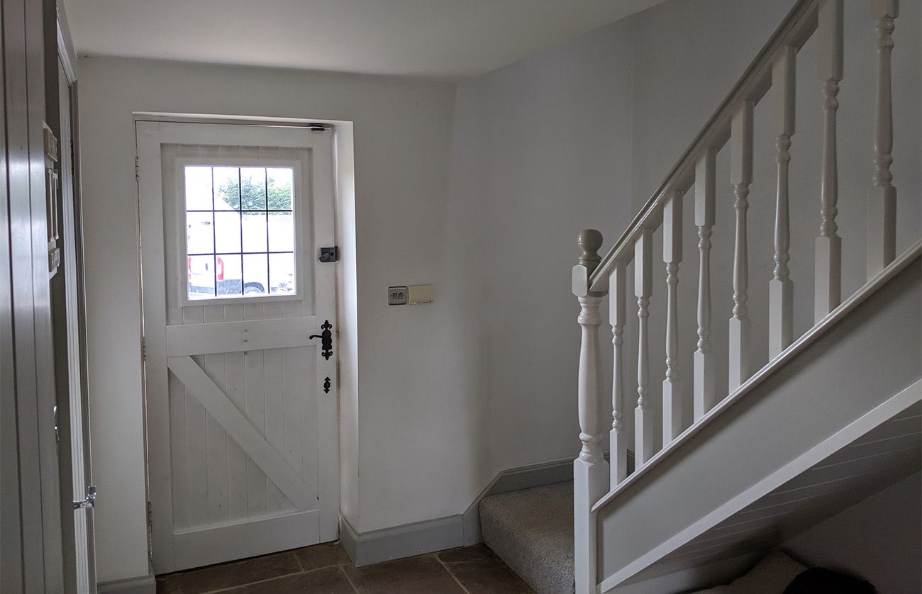 A photo of the hallway before, which was painted grey and white.