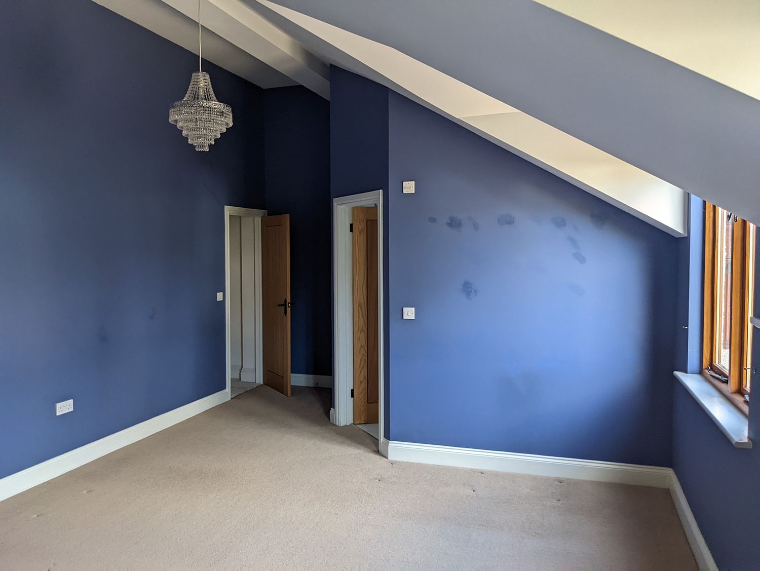 A before photo of the guest bedroom which has purple walls and white woodwork.