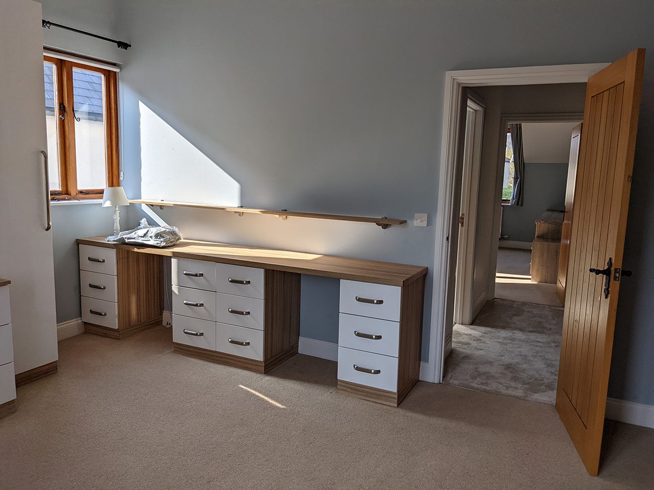 A before photo of the child's bedroom with the desk in place and pale blue walls.