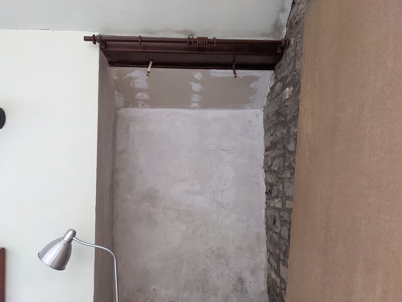 A before photo of the same area which was unplastered and damp.