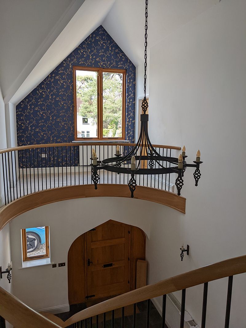 The before image of the hallway with white walls and a black light fitting.